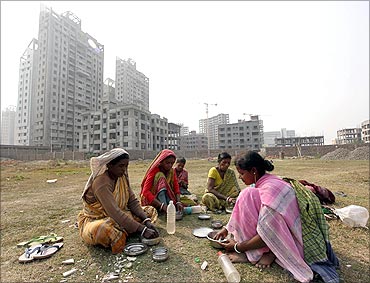 Labourers eat food at the site of a residential estate under construction in Kolkata.
