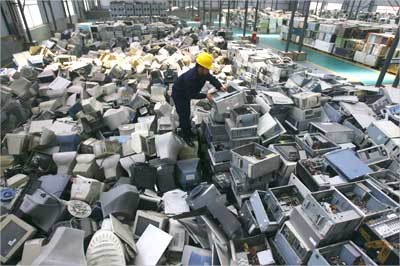 An employee arranges discarded computers at a newly opened electronic waste recycling factory in Wuhan.