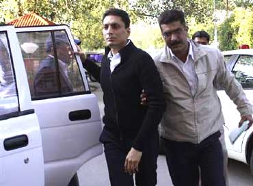 A CBI official escort Shahid Balwa (C, in black).