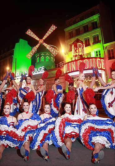 Dancers from the Moulin Rouge in Paris perform their traditional Cancan outside the cabaret.