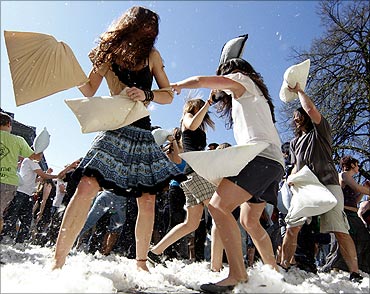 People attend a pillow fight in front of Zurich's catherdal on international Pillow Fight Day.