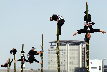 Edo Firemanship Preservation Association members perform atop bamboo ladders in Tokyo.