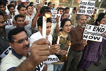 Supporters of Anna Hazare hold placards in a protest against corruption.