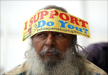 A demonstrator wears a sticker on his forehead during a protest rally against corruption.