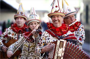 Musicians dressed as traditional Flinserl participate in a carnival parade in Styria.
