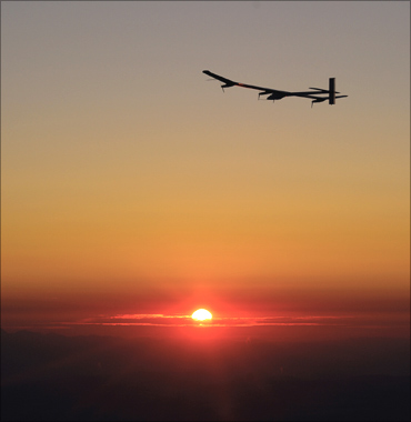 Andre Borschberg flies the solar-powered HB-SIA prototype airplane at sunrise.