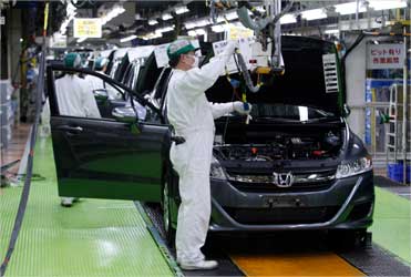 Workers assemble cars at Honda Motor's Saitama factory in Sayama, north of Tokyo.