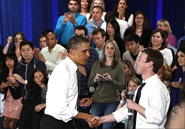 US President Barack Obama shakes hands with Facebook CEO Mark Zuckerberg at a townhall meeting at Facebook headquarters in Palo Alto, California..