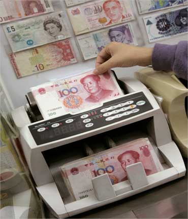 Yuan notes are counted at a currency exchange office in Hong Kong January.
