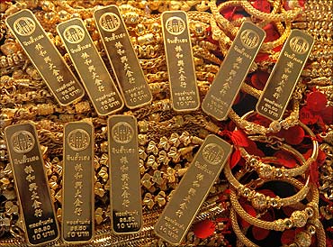 Gold bars and jewellery are displayed in a shop.
