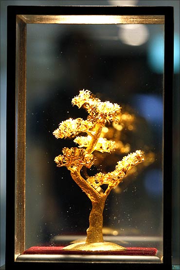 A gold replica of a pine tree displayed at a jewellery shop.