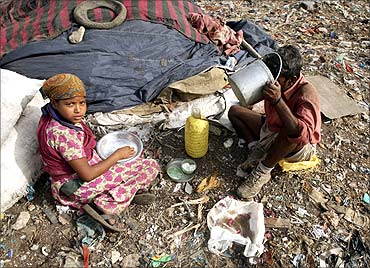 Rag pickers eat their lunch near a dump in New Delhi.