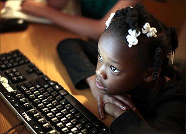 Jayla studies on a computer at the shelter where she lives in Los Angeles.