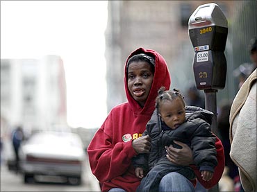 Rochelle Benbow and her son Norman wait in line for a Thanksgiving meal served to the homeless.