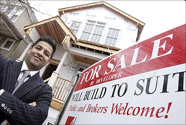 Developer Azeem Kahn poses outside a home he is building in Chicago.