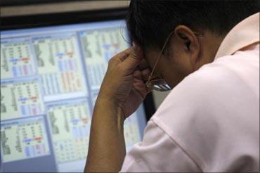 This file photograph shows a trader reacting over fall in the stock market. 