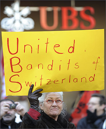 A woman demonstrates in front of Swiss bank UBS headquarters in Zurich.