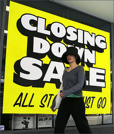 A woman walks past a closing store in east Sydney.