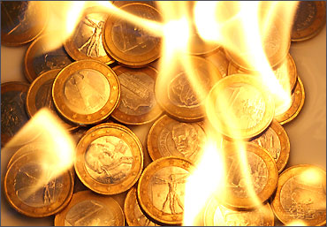 Several one euro coins are pictured in flames in this illustration photo taken in Vienna.