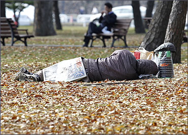 A homeless man sleeps at a park in Tokyo.