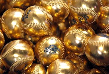 Gold baseballs that are to be thrown out for the first pitch by the Superbowl Champions.