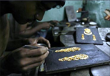 An artisan makes gold ornaments at a jewellery factory in Kolkata.