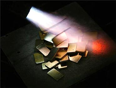 Gold biscuits are given finishing touches at a precious metals refinery in Mumbai.