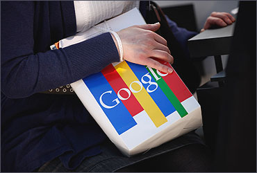 A visitor clutches a paper bag from online giant Google at the CeBIT technology trade fair.