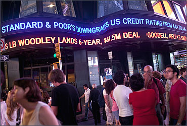 An ABC News ticker reads Standard and Poor's downgrades US credit rating.