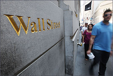 People walk on Wall Street outside the New York Stock Exchange.