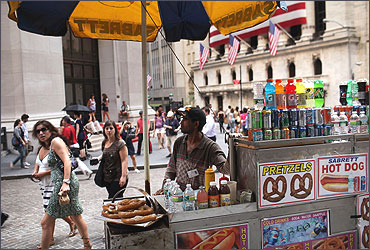 A food vendor is stationed in front of the New York Stock Exchange.
