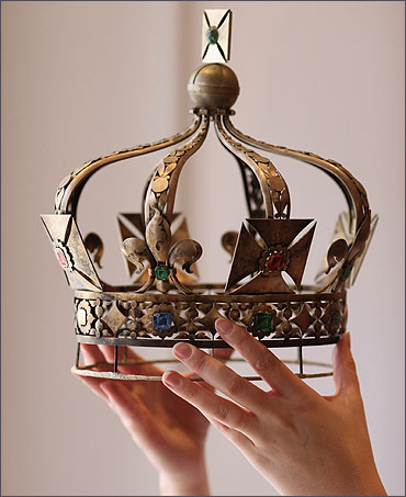 A woman holds a model used in the production of the Imperial State Crown of India.
