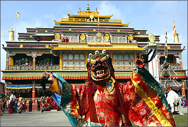 A Buddhist monk performs chaam (masked) dance inside the complex of Palchen Choeling monastery.