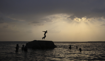 A boy jumps into the waters of the Osman Sagar Lake near Hyderabad.