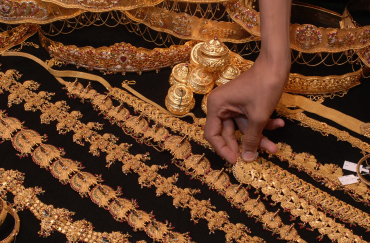 A salesman arranges gold jewellery at a shop in Hyderabad.
