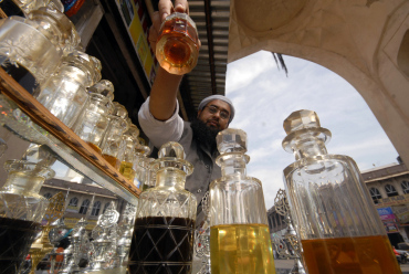 A man arranges bottles of perfume in Hyderabad.