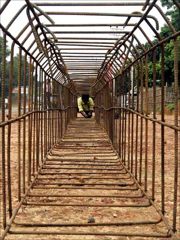 A labourer works at a road construction site on the outskirts of Agartala.