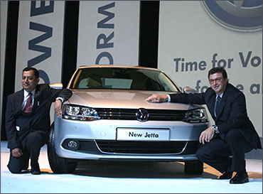 Neeraj Garg Member of Board and director, Volkswagen Passenger Cars and Lutz Kothe head of marketing and PR pose with the car.