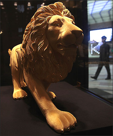 A gold statue of a lion is displayed at a jewellery shop in Hong Kong.