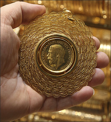 A man shows a gold medal in his shop in Damascus.