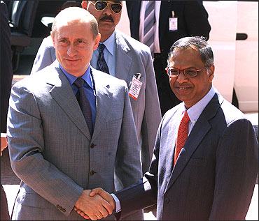 Russian President Vladimir Putin (L) shakes hands with N R Narayana Murthy.