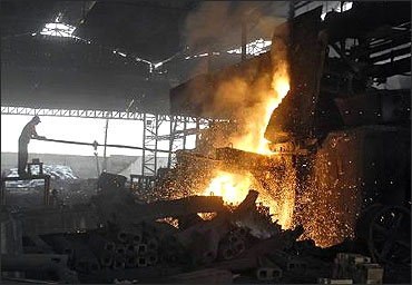 A labourer works in an iron factory.