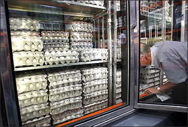 A shopper buys eggs in a large chain food store.