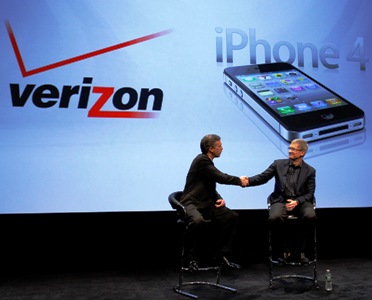 Verizon Wireless president and CEO Mead shakes hands with Apple CEO Tim Cook.