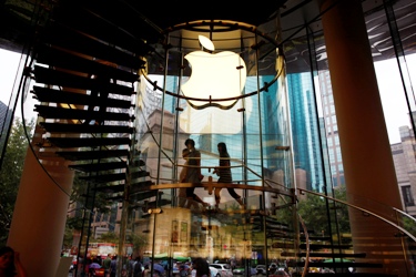 People walk inside an Apple retail store in Shanghai.