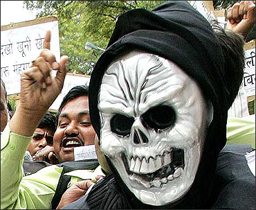 An Indian trader wears a mask during a protest against the Value Added Tax.