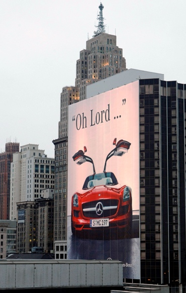A 21-story outdoor poster for Mercedes-Benz is seen across from Cobo Center in Detroit.