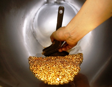 A worker uses a brush to gather gold shots at a jewellery factory in Chiba, east of Tokyo.