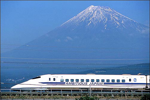 Shinkansen bullet train speeds past Mt. Fuji Japan.