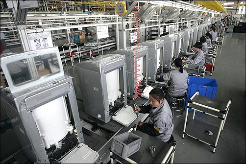 Employees work at a washing machine production line at Hefei.